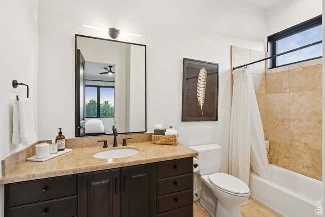 Full bathroom with vanity, shower / bath combo with shower curtain, and ensuite bath | Image 60