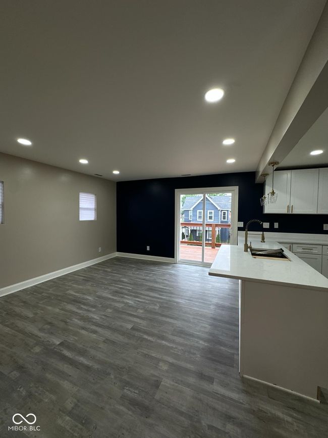 Unit 2 - unfurnished living room with recessed lighting, healthy amount of natural light, and dark wood-style flooring | Image 18