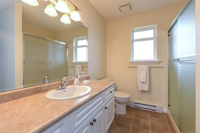 Bedroom with carpet floors, baseboard heating, and baseboards | Image 10