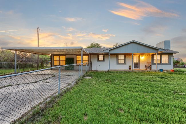 View of front of house with a chimney, a front lawn, fence, and a carport | Image 36