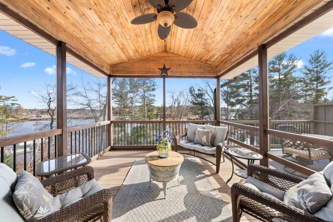 Ah-mazing 3 season porch overlooks the glimmering lake and dock. | Image 10