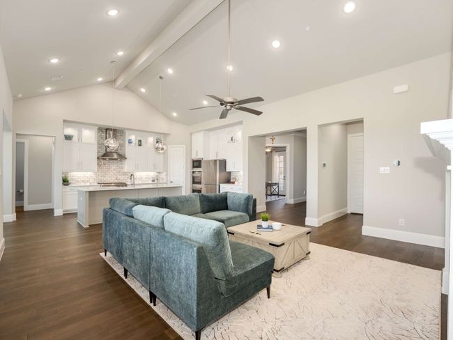 Spacious living room is a wood burning gas fireplace | Image 11