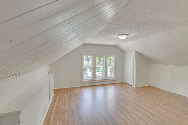 Additional living space featuring lofted ceiling and light wood-style floors | Image 14