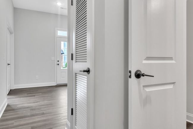 As you enter from the 2 car garage a half bath is on the right and in front of you lies the entry foyer and flex office area to the left of foyer. | Image 8