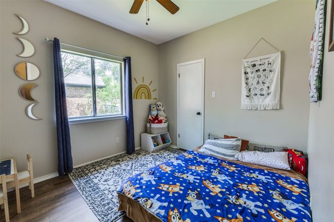 Bedroom with wood finished floors, baseboards, and a ceiling fan | Image 16