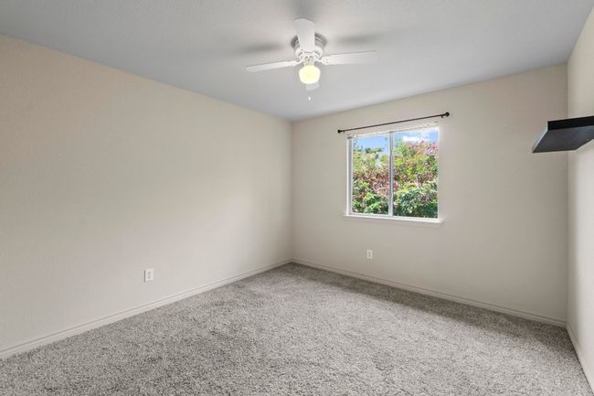 High ceilings, a ceiling fan, and a walk-in closet in this bedroom. | Image 21