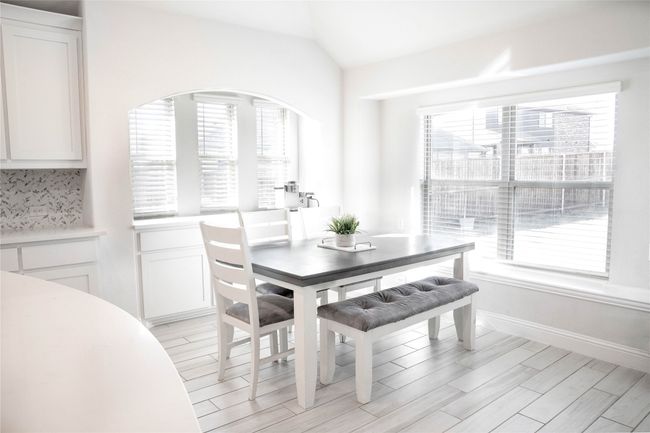 Dining space featuring baseboards, vaulted ceiling, and light wood-style flooring | Image 5