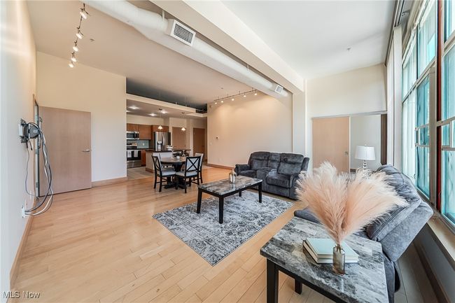 Great room featuring track lighting and light wood finished floors. | Image 8