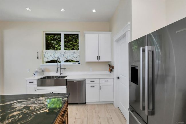 Kitchen with appliances with stainless steel finishes, white cabinets, recessed lighting, and light countertops | Image 48