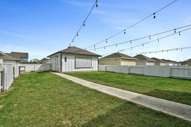 Flat and spacious backyard with a detached 2 car garage. | Image 23