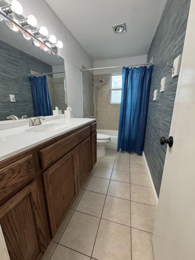 Bathroom with tile patterned floors, vanity, and shower / bath combo | Image 8