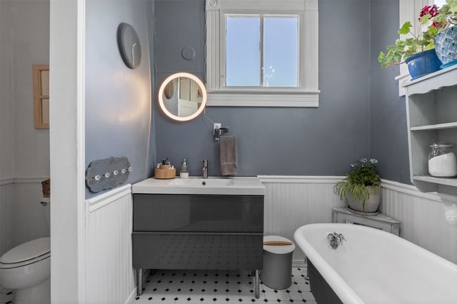 Full bath with wainscoting, a freestanding tub, and vanity | Image 26