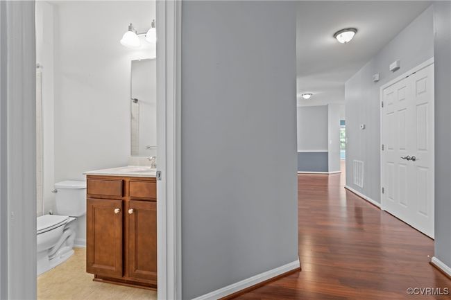 Hall with wood finished floors and baseboards | Image 25