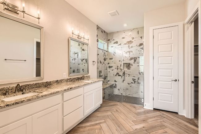 Bathroom featuring recessed lighting, double vanity, a marble finish shower, and a sink | Image 19
