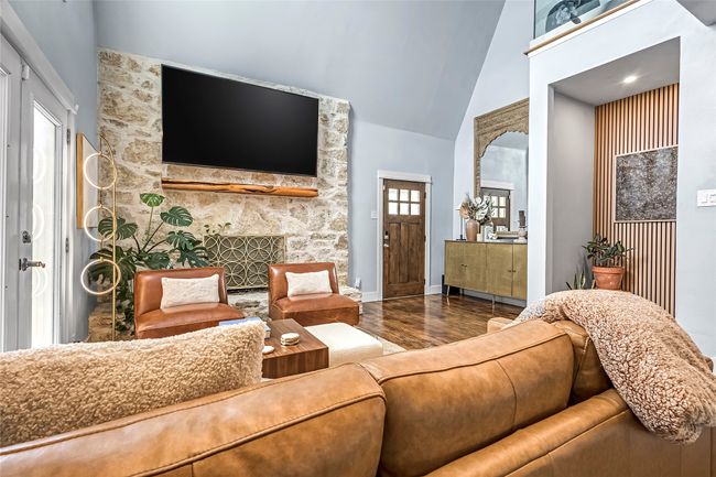 Living area with wood finished floors, baseboards, and vaulted ceiling | Image 5