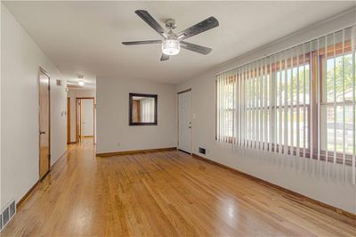 Unfurnished room featuring light hardwood / wood-style floors and ceiling fan | Image 3