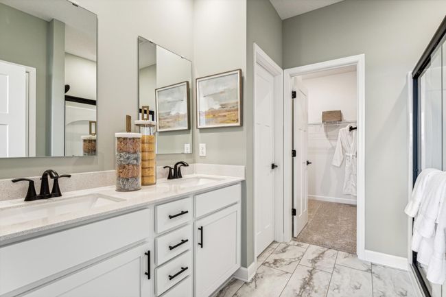 Photo is of the actual model. The primary bath includes a double-vanity and a large shower. | Image 10