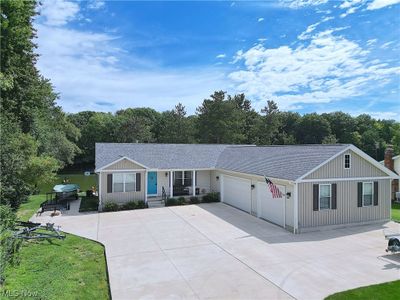 Ranch-style home with a garage and a front lawn | Image 2