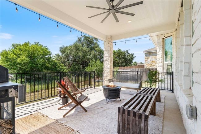 View of patio featuring a ceiling fan and an outdoor fire pit | Image 39