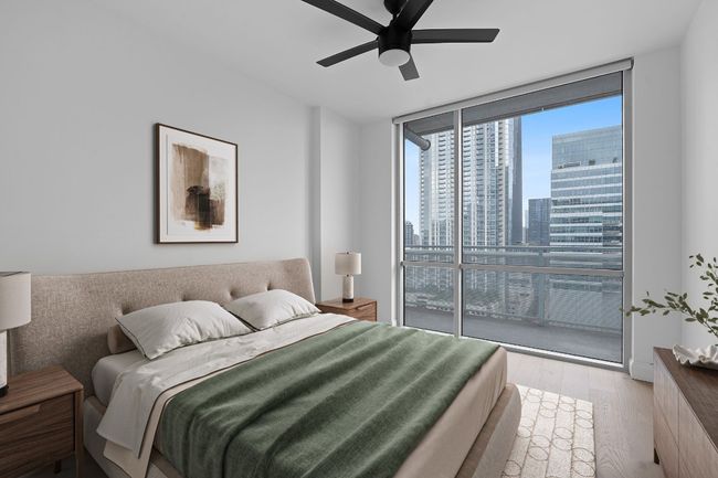 Bedroom with floor to ceiling windows, wood finished floors, a view of skyline, and ceiling fan | Image 7