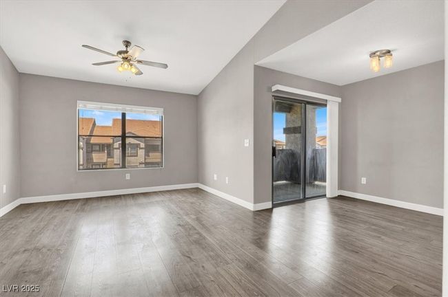 Spare room with baseboards, dark wood-style floors, and ceiling fan | Image 8