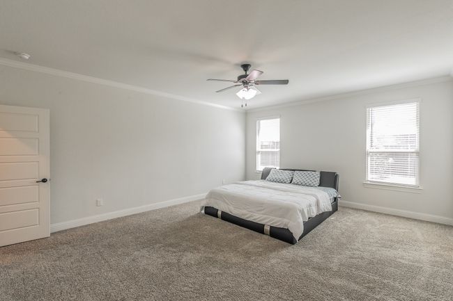 Bedroom featuring carpet, baseboards, and ornamental molding | Image 25