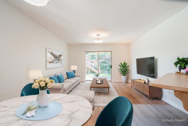 Living room featuring light wood-type flooring and baseboards | Image 16