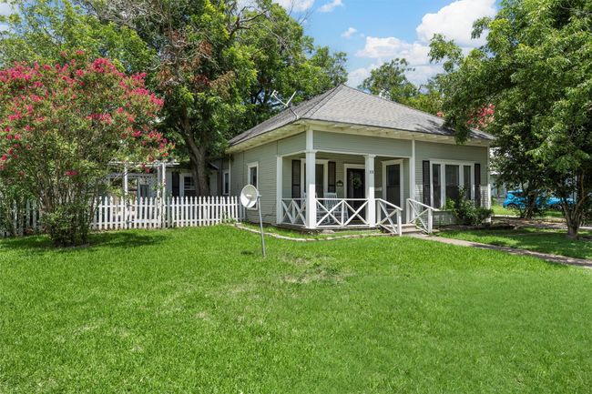 Rear view of house featuring a porch and roof with shingles | Image 4