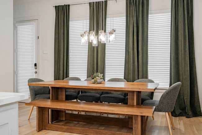 Dining room with an inviting chandelier and light wood-style floors | Image 15