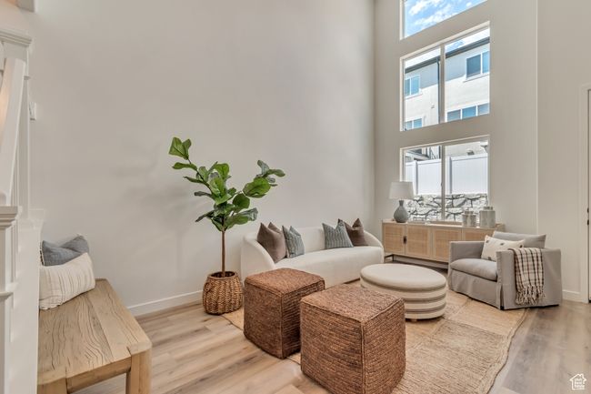 Living room featuring baseboards, light wood finished floors, and a towering ceiling | Image 5