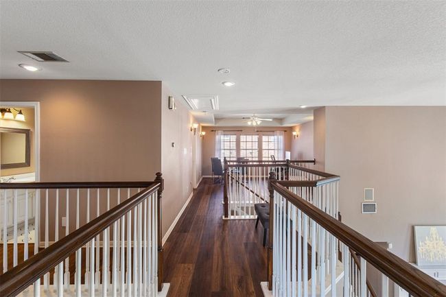 Landing has an overlook facing towards the back of the home with breath taking views of the pool in the evenings. | Image 27