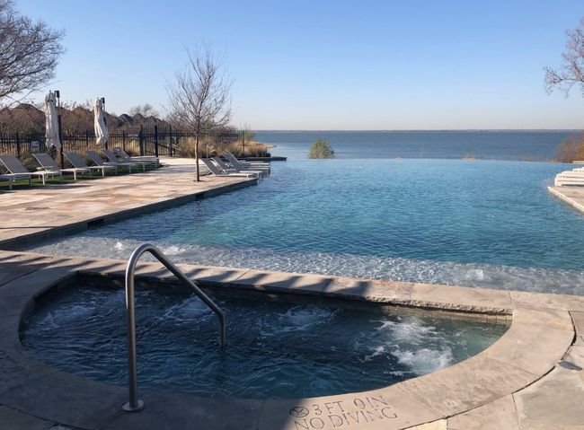 Residents enjoy exclusive access to neighborhood pool area featuring a negative edge pool-spa overlooking the lake | Image 39