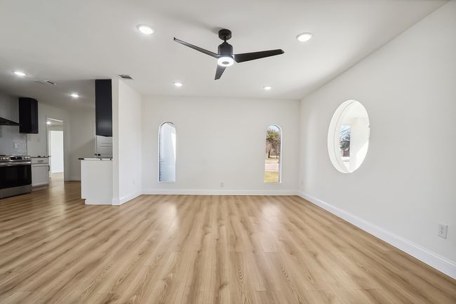 Unfurnished living room featuring light wood-type flooring, baseboards, visible vents, and recessed lighting | Image 5