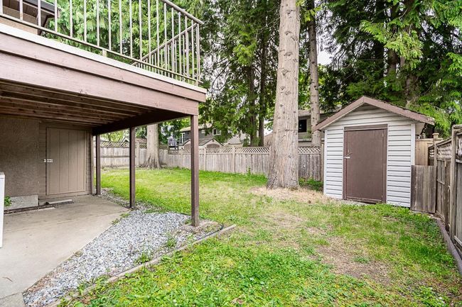 Fenced backyard featuring a shed | Image 34