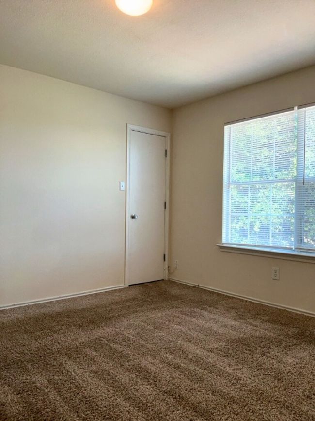 Bedroom featuring dark carpet and baseboards | Image 13