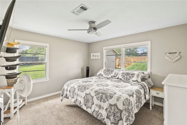 Bedroom with carpet, multiple windows, and a ceiling fan | Image 17