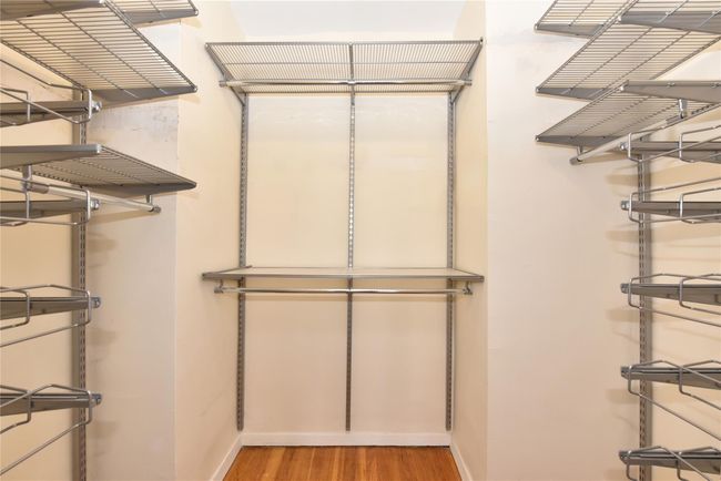 Walk in closet with hardwood / wood-style flooring | Image 19