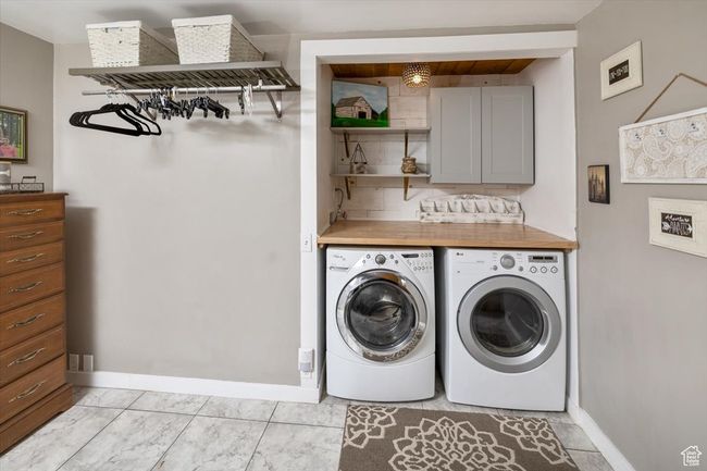 Washroom with separate washer and dryer and light tile patterned floors | Image 22