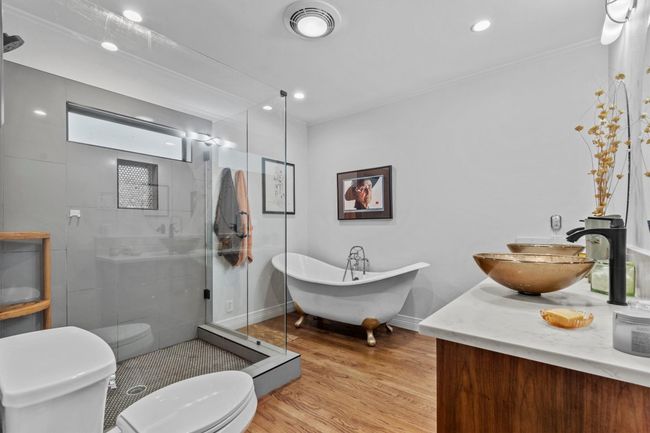 MAIN: Primary bathroom with both walk-in shower and claw foot soaking tub. | Image 14