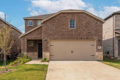 Front facade with a front lawn, and a garage | Image 1