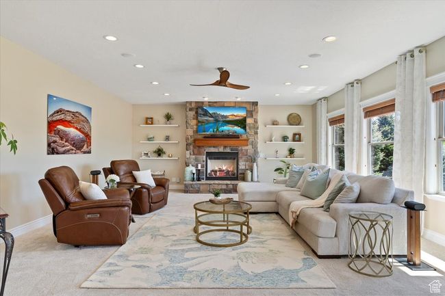 Living area featuring recessed lighting, baseboards, light carpet, and a fireplace | Image 10
