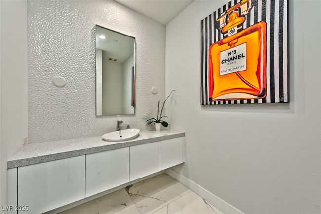 Bathroom featuring baseboards, marble finish floor, visible vents, and vanity | Image 13