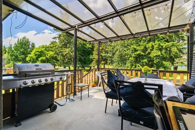 View of patio featuring outdoor dining space, a pergola, and a grill | Image 33