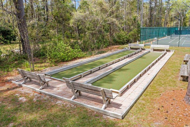 View of home's community featuring a view of trees and fence | Image 39