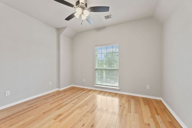 Empty room with hardwood / wood-style flooring, ceiling fan, and lofted ceiling | Image 29