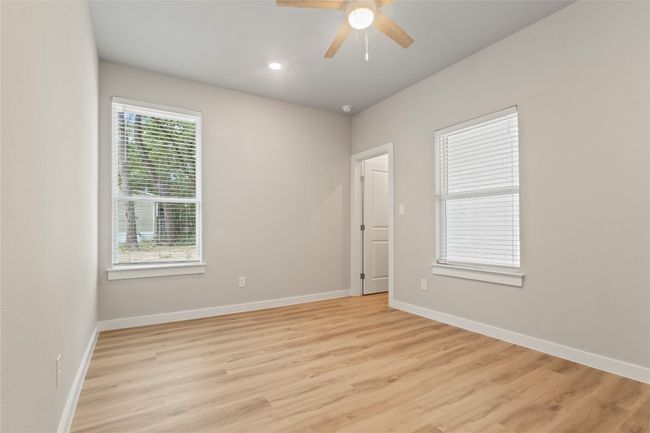 A bright, spacious bedroom with abundant natural light and generous closet space—crafted for comfort and style. | Image 25