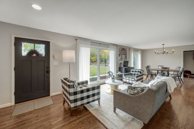 Open Living and Dining Room is filled with Natural Light with New Energy Efficient Windows throughout the Home plus Hardwood Floors | Image 6