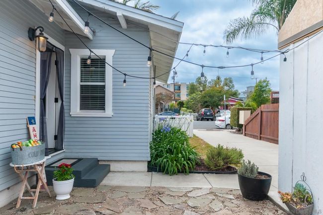 Sideyard, detached one car garage and driveway with tandem parking for two cars. | Image 21