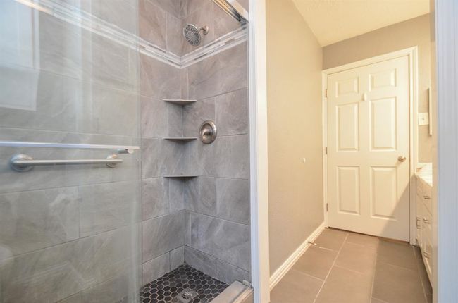 Full hall bath walk in shower- also beautifully updated- corner shelves and gorgeous tile design | Image 21