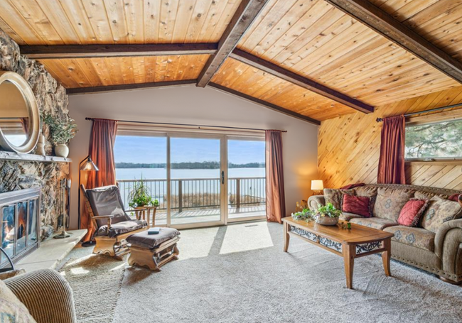 Upper level living room with panoramic views of the lake and walk out access to the large deck | Image 21